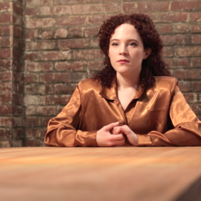 Sarah Schoofs as Jennifer awaiting the verdict of her clients.
