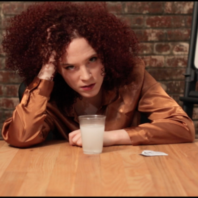 Hungover Jennifer (Sarah Schoofs) waiting on her clients.