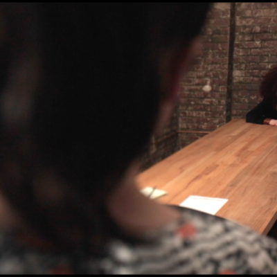 Lee (Lauren Shaw) kicking Jennifer (Sarah Schoofs) out of the conference room.